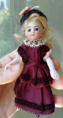 Antique French all bisque Mignonette doll with closed mouth & fixed blue glass eyes, dated about 1890.