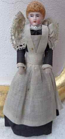 Antique dollhouse doll, a lovely maid with original old dress with long apron, made about 1910.