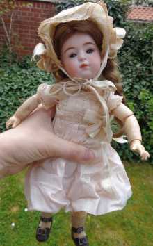 German antique character doll, a lovely girl with closed mouth, dated about 1900.